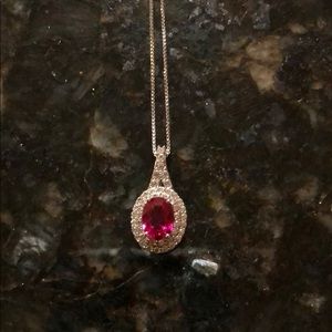 Ruby stone necklace with diamonds all around.